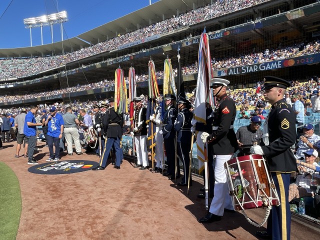 A Joint Armed Forces Color Guard and drummers from The United States Army Field Band prepare to present the colors at the MLB All Star Game in Dodger Stadium, Los Angeles, July 19, 2022.