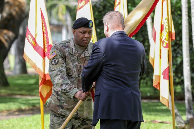 Craig L. Deatrick, accepts the unit colors from Command Sgt. Maj. Jason R. Copeland