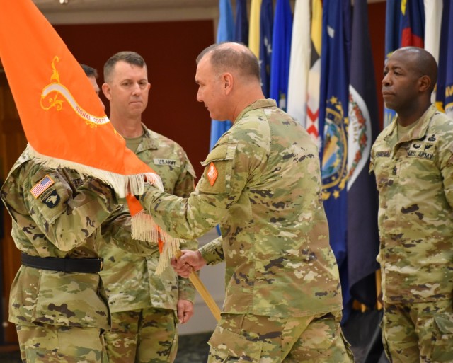 Col. James D. Turinetti IV, outgoing U.S. Army Signal School commandant and 41st Chief of Signal, passes the guidon to Brig. Gen. Paul T. Stanton, Cyber Center of Excellence and Fort Gordon commanding general, during a change of responsibility ceremony held July 15.