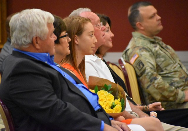 Madeline (center), daughter of Col. Paul D. Howard, U.S. Army Signal School commandant and 42nd Chief of Signal, was presented with a bouquet of yellow flowers on behalf of Howard&#39;s wife, Lisa, who was attending the change of responsibility ceremony virtually. 