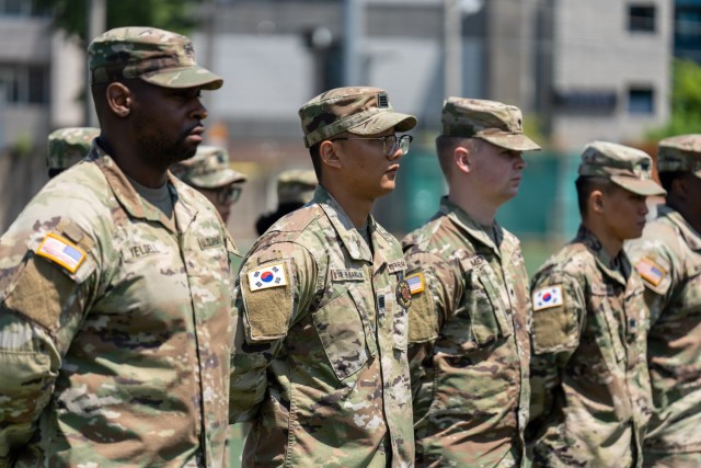 Soldiers and KATUSAs assigned to Headquarters and Headquarters Company, U.S. Army Garrison Daegu stand shoulder-to-shoulder during a change of command ceremony at Camp Henry, Republic of Korea, May 25, 2022. KATUSAs, which stands for Korean Augmentation To the United States Army,  are Soldiers in South Korea’s Army serving alongside their U.S. Army counterparts who provide language and cultural support in addition to their regular duties.