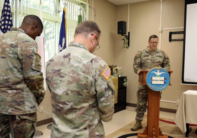 Maj. Andrew Calvert, right, acting chaplain for U.S. Army Garrison Japan, recites an invocation during a ceremony to celebrate the 247th anniversary of the Army Chaplain Corps at Camp Zama, Japan, July 29, 2022.
