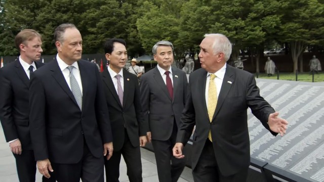 Retired Army Gen. John H. Tilelli Jr., chairman of the Korean War Veterans Memorial Foundation, right, leads a tour of the Korean War Veterans Memorial in Washington. The group includes Jake Sullivan, national security advisor, left; Second Gentleman Douglas Emhoff, left of center; and representatives from the South Korean government, July 27, 2022.
