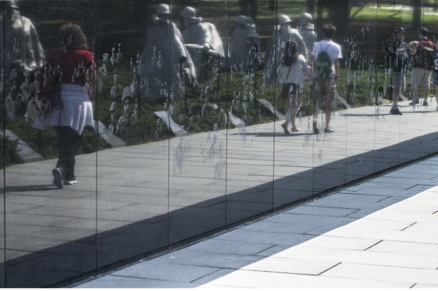 Visitors to the National Mall at Washington observe the Korean War Memorial on a beautiful spring day, April 21, 2015.
