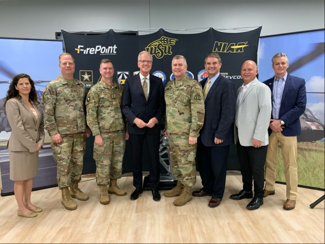 From left to right: Cindy Ponder, Maj. Gen. Wally Rugen, Maj. Gen. Todd Royar, Sen. Jerry Moran, Brig. Gen. Rob Barrie, Mr. Jeff Langhout, Dr. John Tomblin, and Dr. Rick Muma kicked off a partnership between the U.S. Army and the National Institute for Aviation Research July 29, 2022, in Wichita, Kansas, to create an Apache Digital Twin, which takes apart an existing helicopter to scan each part to create 3D models.