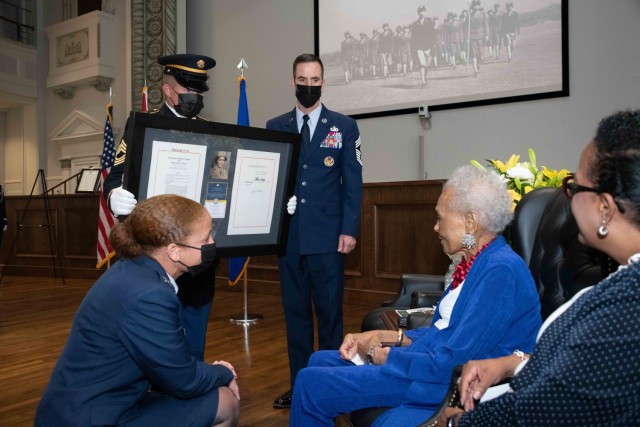 Col. Eries Mentzer, Commander, 42d Air Base Wing, Chief Master Sgt. Lee Hoover, Command Chief Master Sergeant, 42d ABW, and an Alabama National Guard Honor Guardsman present the framed citation of the Congressional Medal of Honor to Private Romay Catherine Johnson Davis at Montgomery City Hall, July 26, 2022.

President Joe Biden approved the Congressional Gold Medal presentation to the women of the 6888th Central Postal Directory Battalion, an all-female, all-African American unit that resolved a backlog of more than 17 million pieces of mail during World War II. Mrs. Davis is the oldest living member of the 6888th. 

The 26th of July is the 74th Anniversary of Executive Order 9981 that integrated the Armed Forces.