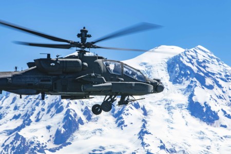 Army Col. Shane Finison flies an AH-64E Apache helicopter near Mount Rainier, Wash., July 11, 2022, during his final flight as commander of the 16th Combat Aviation Brigade.