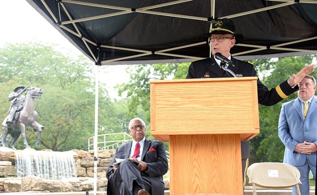 Combined Arms Center and Fort Leavenworth Commanding General Lt. Gen. Theodore Martin delivers remarks, flanked by guest speaker retired Navy Cmdr. Carlton Philpot, left, and ceremony narrator Charles Davis, Visitors and Ceremonies officer, Army University, right, during a ceremony marking the 30th anniversary of the Buffalo Soldier Monument’s dedication July 28 in the Buffalo Soldier Commemorative Area at Fort Leavenworth, Kan.