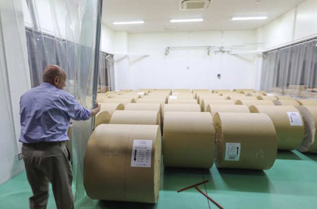 Michael Ryan, chief of staff for Stars and Stripes Pacific, reveals 1,000-pound rolls of paper that are used to make the newspaper at its offices located at Akasaka Press Center, Japan, July 28, 2022. The installation, which is managed by U.S. Army Garrison Japan, also has a recreational lodge called Hardy Barracks, where military personnel and families can stay when exploring Tokyo. 