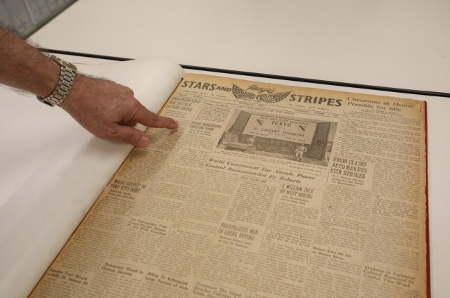 Michael Ryan, chief of staff for Stars and Stripes Pacific, shows the first copy of the newspaper that was printed in Japan in 1945 while inside an archive at Akasaka Press Center, Japan, July 28, 2022. A photo on the front page of the newspaper, published on Oct. 3, 1945, touts the 1st Cavalry Division as the first U.S. Army unit to guard Tokyo.