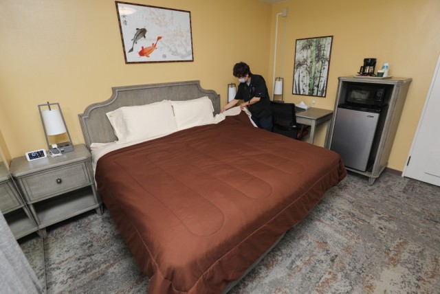 Masakazu Hoshi, a housekeeper at Hardy Barracks, prepares a guest room inside the recreational lodge at Akasaka Press Center, Japan, July 28, 2022.  The lodge recently remodeled its 35 rooms that are roughly twice the size of those at hotels outside the installation.
