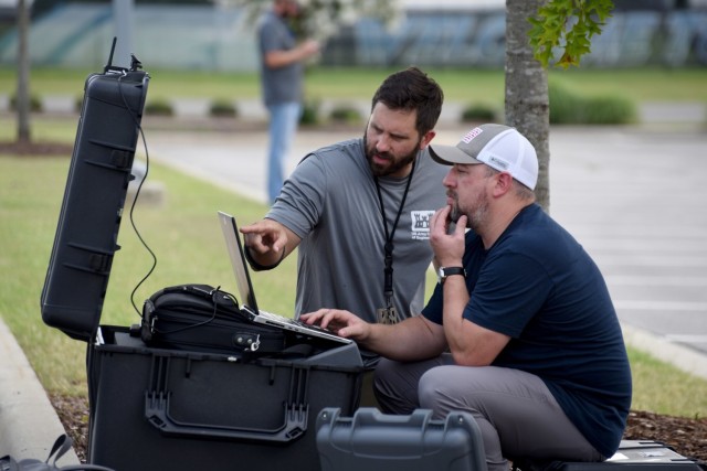 Huntsville Center&#39;s Brian Roden (L) and Josh Mason monitor a flight over the UAH campus.