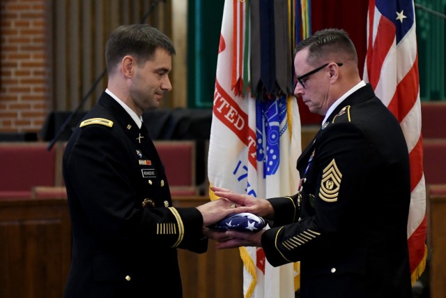 Col. Michael Kovacevic, Executive Officer to the Director of the Army Staff, passes the flag to Combined Arms Center-Training Senior Enlisted Advisor Sergeant Maj. Thomas Conn during his retirement ceremony at Pioneer Chapel, Fort Leavenworth, Kan. July 29, 2022. Because Conn served as a Command Sgt. Maj. in previous assignments, he retired with that rank. Kovacevic traveled from the D.C. area to preside over the ceremony. Conn was the command sergeant major for the 101st Airborne Division’s 2nd Brigade Combat Team when Kovacevic commanded the unit. Photo by Tisha Swart-Entwistle, Combined Arms Center-Public Affairs.