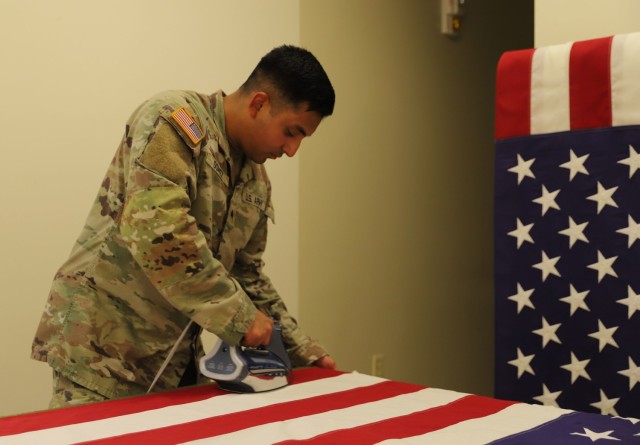 Mortuary Affairs Soldier Prepares Flag