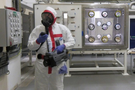 Maj. Joshua Mashl, a nuclear operations officer on Nuclear Disablement Team 1, conducts a radiation survey within the glovebox training facility at Sellafield Site, United Kingdom, during a training exercise, May 2022.  