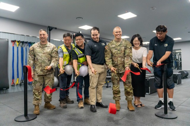 Members of the U.S. Army Garrison Daegu team officially re-open the Wall Fitness Center at Camp Henry, Republic of Korea, Aug. 5, 2022. The upgraded fitness center now has a dedicated functional fitness area to help Soldiers prepare for their Army Combat Fitness Tests.