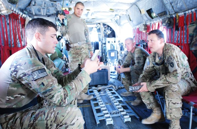 U.S. Army 1st Lt. Jared Thompson, foreground, a CH-47 Chinook helicopter pilot, provides a mission brief to Staff Sgt. Ignacio Lopez, back left, Pfc. Zach Fike, back right, and Chief Warrant Officer 3 Andre Lavallee, right, prior to a personnel and equipment movement mission at Bagram Airfield, Parwan province, Afghanistan, Sept. 22, 2013. The Soldiers were assigned to Bravo Company, 2nd Battalion, 149th Aviation Regiment, Texas and Oklahoma Army National Guard, attached to the 10th Combat Aviation Brigade. 
