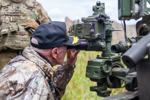 Mr. Hilton Labow, a 98 year-old WWII Veteran, looks down the sight on a M119 A2 Howitzer on August 10, 2022. Mr. Labow Visited Fort Drum and watched a live fire exercise conducted by 2nd Battalion, 15th Field Artillery Regiment, 2nd Brigade Combat Team, 10th mountain Division.
