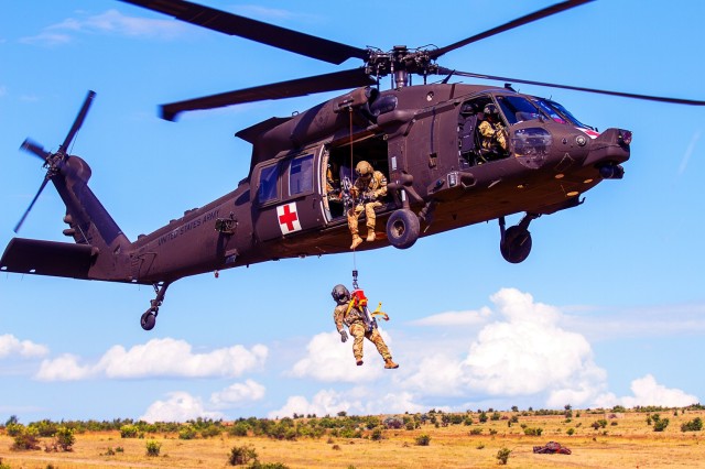 An HH-60 medevac helicopter and crew assigned to C Company, 2-227 General Support Aviation Battalion hoist a simulated casualty during personnel recovery training with the United Kingdom in the Babadag Training Area, Romania July 12, 2022.
