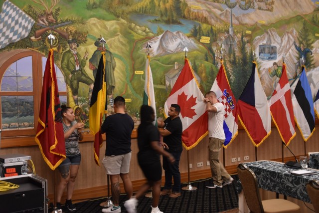 Soldiers from U.S. Army NATO Brigade pack up the flags representing 30 NATO nations at the conclusion of the Senior Army Leaders Meeting XXI in Garmisch, Germany on August 4. 