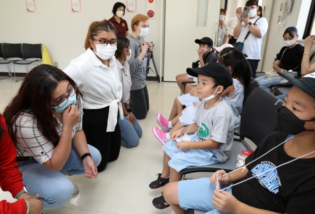 Soldiers assigned to the 623rd Movement Control Team introduce themselves to Japanese students during an outreach event at the Sagamihara Shiritsu Oyama Community Center, Japan, Aug. 10, 2022. The Soldiers later played games with the students to...