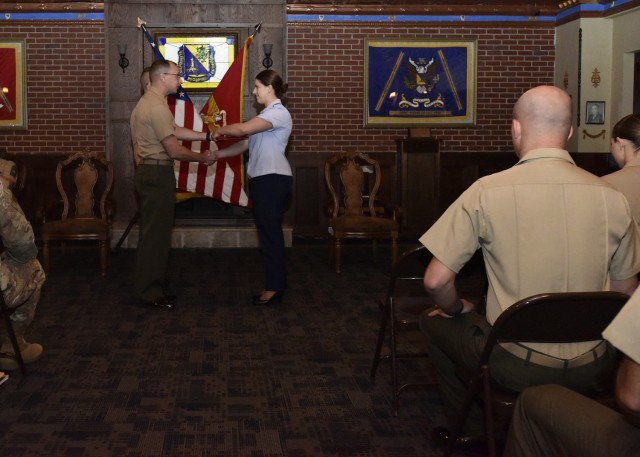 Air Force 1st Lt. Rita Bowen accepts her diploma and recognition as distinguished honor graduate today in the Chemical, Biological, Radiological and Nuclear Regimental Room at the John B. Mahaffey Museum Complex from Marine Chief Warrant Officer 5...