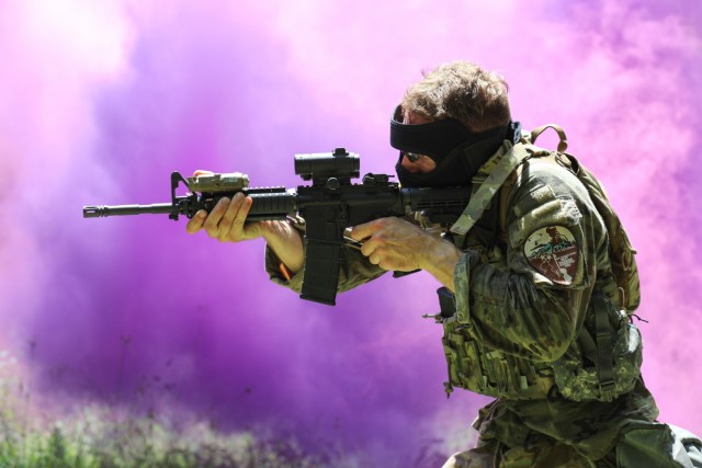 Army Sgt. Spencer Fayles, a combat medic assigned to the Utah National Guard’s 144th Area Support Medical Company, shoots targets through smoke during the 2022 Army National Guard Best Warrior Competition at the Volunteer Training Site in...