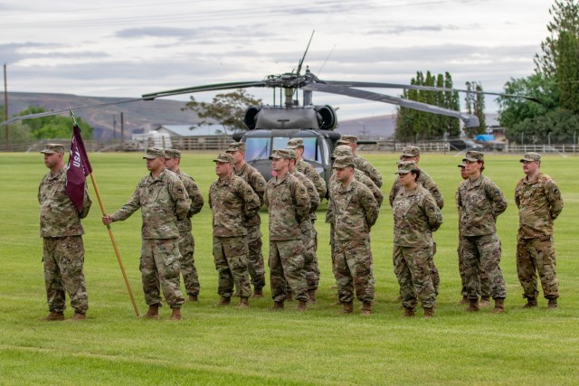 Soldiers assigned to U.S. Army Air Ambulance Detachment Yakima, 2-158 Assault Helicopter Battalion, 16th Combat Aviation Brigade stand in formation at the detachment&#39;s change of command ceremony at Yakima Training Center, Wash. on Jun. 9, 2022.