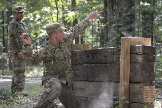 Army Sgt. Richard Carlson throws a practice grenade during the 2022 Army National Guard Best Warrior Competition at the Volunteer Training Site in Tullahoma, Tenn., July 27, 2022.