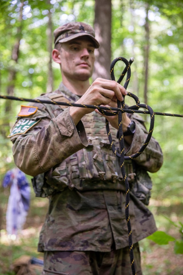 U.S. Army Sgt. Spencer Fayles, a combat medic assigned to the Utah National Guard’s 144th Area Support Medical Company, learns how to tie a bowline knot during the Army National Guard Best Warrior Competition in Milan, Tenn., July 26, 2022.
