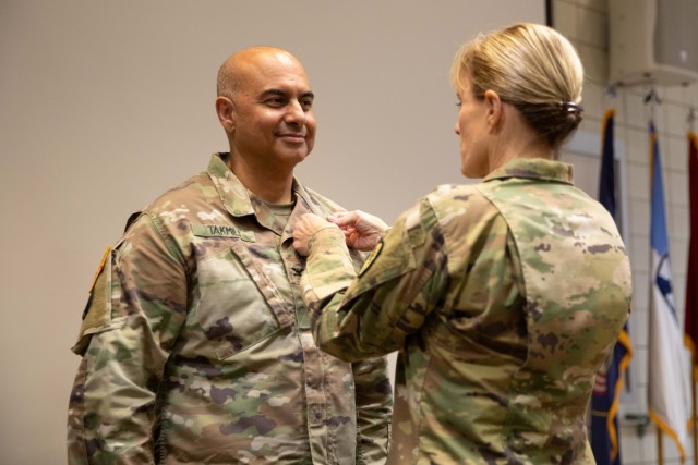 Col. Shahram Takmili receives the Legion of Merit from Brig. Gen. Charlene Dalto for meritorious service while serving as the commander of the 300th Military Intelligence Brigade during a change-of-command ceremony, Aug. 6, 2022, at Camp Williams, Utah. During the ceremony, Col. Shahram Takmili relinquished command to Col. Cody Strong. (U.S. Army photo by Staff Sgt. Derrik Cowley)