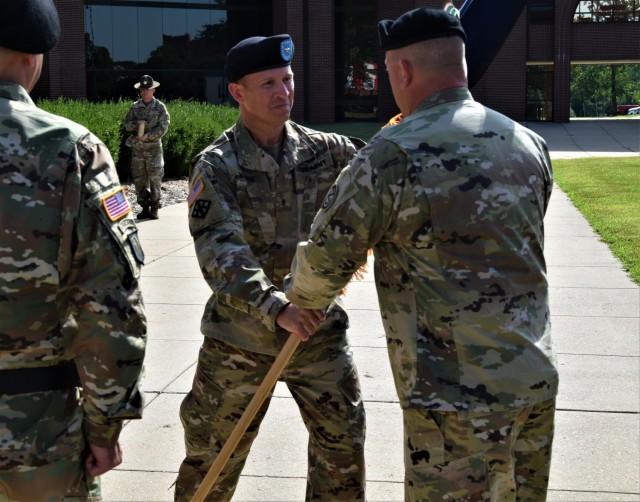 Brig. Gen. Matthew S. Warne, incoming commanding general 102nd Training Division, returns the unit colors back to Command Sgt. Maj. James Lamberson, senior enlisted advisor, 102nd Training Division, during the division&#39;s change of command ceremony at the Maneuver Support Center of Excellence Plaza at Fort Leonard Wood, Missouri, Aug. 13, 2022.