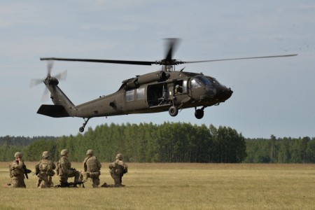 A UH-60 Black Hawk helicopter hovers above U.S. Army Soldiers during a multinational training exercise in Poland in 2017. The Army, which first began using Black Hawk helicopters in the late 1970s, has made iterative upgrades to the machine over the years and is pursuing additional, tech-enabled improvements for the future. The Army is also evaluating opportunities to introduce new helicopter models as part of its Future Vertical Lift modernization effort.