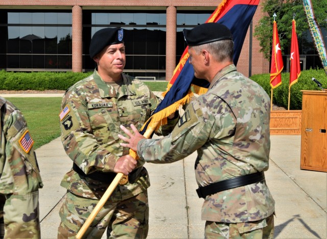 Outgoing Commanding General Brig. Gen. Kokaska, 102nd Training Division, passes the unit colors to Maj. Gen. Bowles III, commanding general of the 80th Training Command (TASS), during the 102nd Training Division change of command ceremony at the Maneuver Support Center of Excellence Plaza at Fort Leonard Wood, Missouri, Aug. 13, 2022.