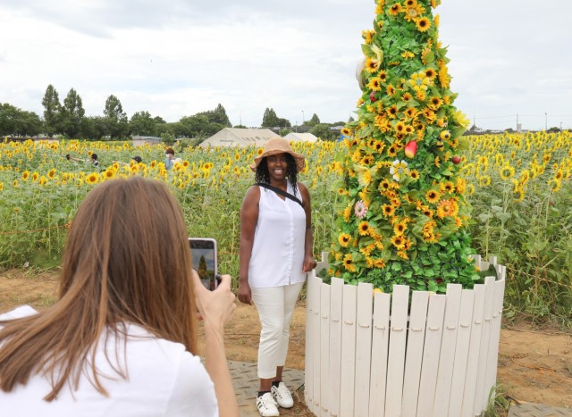 Mary Wanjohi gets her photo taken in front of a field of sunflowers during the Zama Sunflower Festival in Japan, Aug. 12, 2022. The Camp Zama Army Community Service conducted a tour to the festival as part of its efforts to help community members...