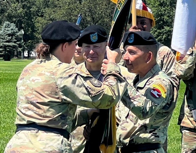 Lt. Gen. Jody J. Daniels, Chief of the Army Reserve receives the colors from Maj. Gen. Miguel Castellanos