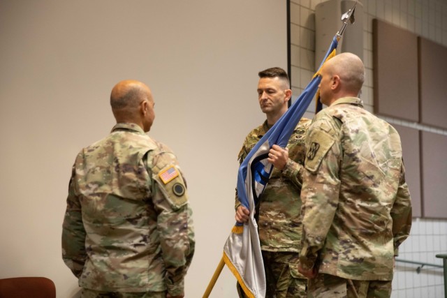 Col. Cody Strong receives the organizational colors from Brig. Gen. Charlene Dalto representing his assuming command during the 300th Military Intelligence Brigade change-of-command ceremony, Aug. 6, 2022, at Camp Williams, Utah. During the ceremony, Col. Shahram Takmili relinquished command to Col. Cody Strong. (U.S. Army photo by Staff Sgt. Derrik Cowley)