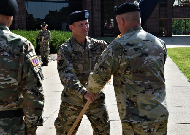 Brig. Gen. Matthew Warne (center) takes the 102nd Training Division (Maneuver Support) guidon from Maj. Gen. Tripp Bowles, commanding general of 80th Training Command - The Army School System, Saturday during a change-of-command ceremony on the...