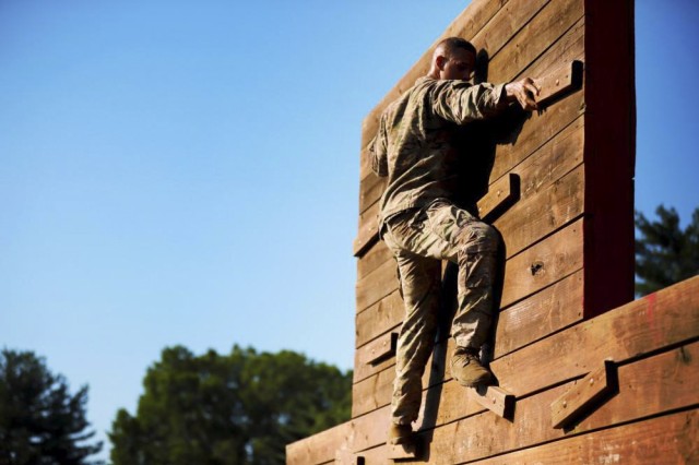 A Soldier climbs an obstacle during the Army Best Squad Competition at Fort Campbell, Ky., July 12, 2022.