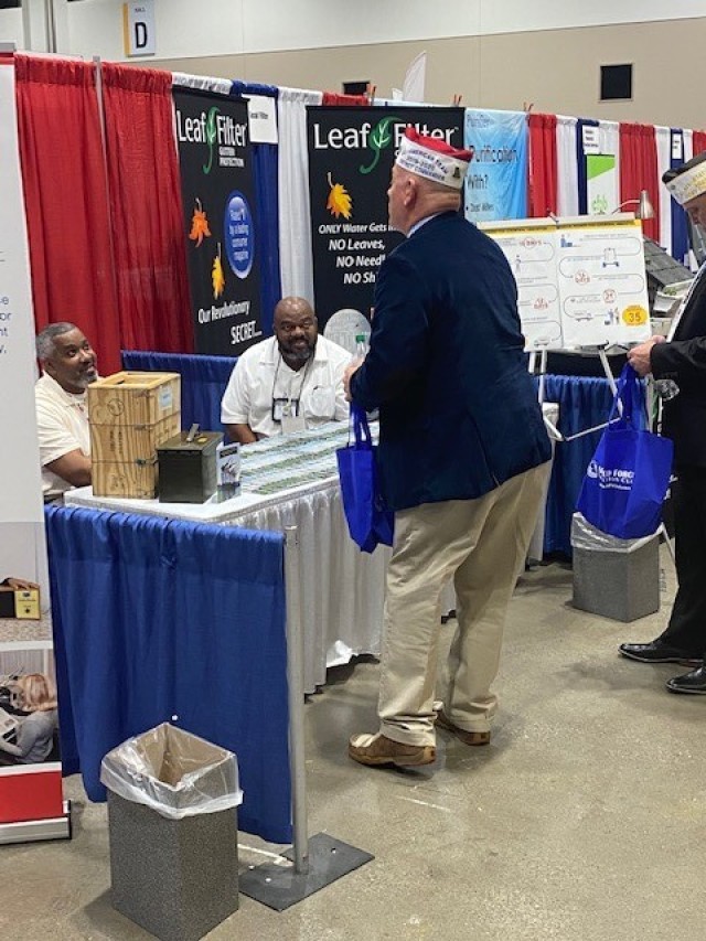 Telacy Biles and Darren Williams discuss ceremonial ammunition processes with a VFW post member at the 122d annual VFW National Convention. 