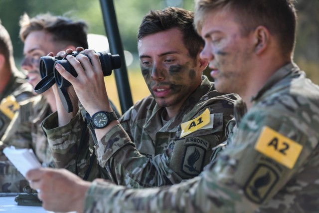 U.S. Army Staff Sgt. Thomas Schneider, center, assigned to U.S. Army Southern European Task Force, Africa, and his squad conduct the call for fire lane during the U.S. Army Europe and Africa Best Squad Competition at Grafenwoehr Training Area, Germany, Aug. 10, 2022.