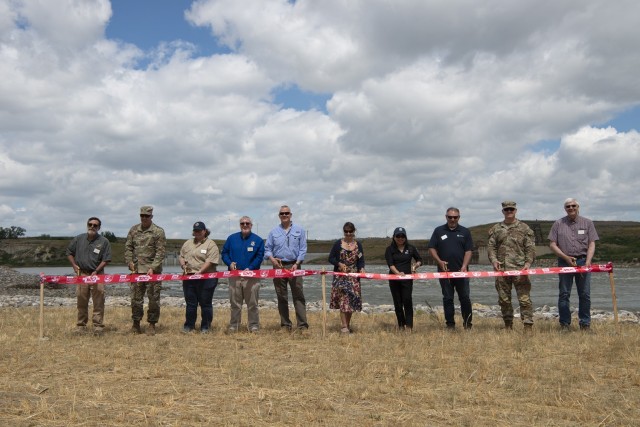 Leadership from the Department of Interior, the  U.S. Army Corps of Engineers, and the U.S. Bureau of Reclamation, cut the ribbon during the ribbon cutting ceremony for the Lower Yellowstone Bypass Channel in Glendive, Mont., July 26, 2022. (U.S. Army Corps of Engineers Photo by Jason Colbert)