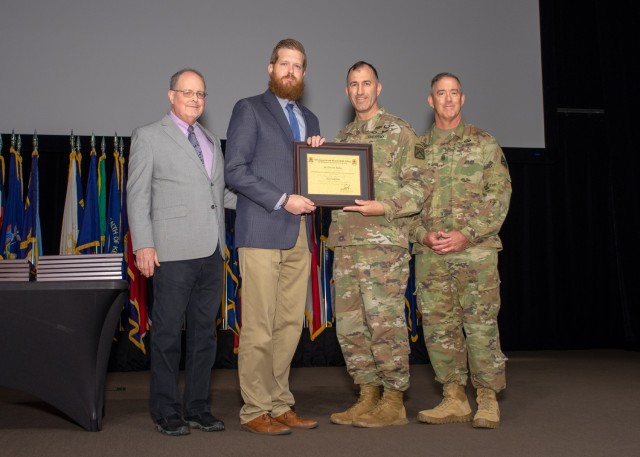 Dr. Eric M. Burke, Army University Press, co-editor of Enduring Success: Consolidation of Gains in Large-Scale Combat Operations, Army University Press, 2022, receives his Gold Pen Certificate from Brig. Gen. David C. Foley, Provost of the Army University and Deputy Commandant of the Command and General Staff College. Dr. Jack Kem, Chief Academic Officer for Army University and Dean of Academics for CGSC, and CSM William D. (Bill) Woods, ArmyU Provost’s Office, assisted in presentation of the awards Aug. 12 at Fort Leavenworth’s Lewis and Clark Center.