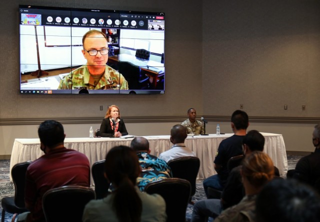 Col. Christopher L. Tomlinson, top left, commander of U.S. Army Garrison Japan, speaks via livestream to garrison employees during a town hall meeting at the Camp Zama Community Club, Japan, Aug. 19, 2022. Tomlinson attended the meeting virtually out of an abundance of caution as he awaited word if he was a COVID-19 close contact. Nearly 300 employees attended the town hall virtually or in-person as leadership addressed concerns and shared updates on programs and services available to the workforce.