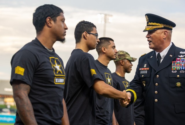 Lt. Gen. James M. Richardson, Acting Commanding General of AFC, shakes the hands of recruits. 