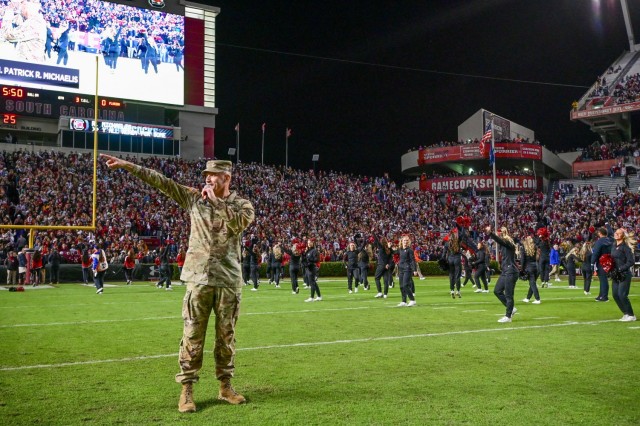 Brig. Gen. Patrick R. Michaelis, Fort Jackson commander, points to one side of Williams-Brice Stadium as he leads the traditional Gamecocks cheer during the Nov. 6 Salute to Service football game.