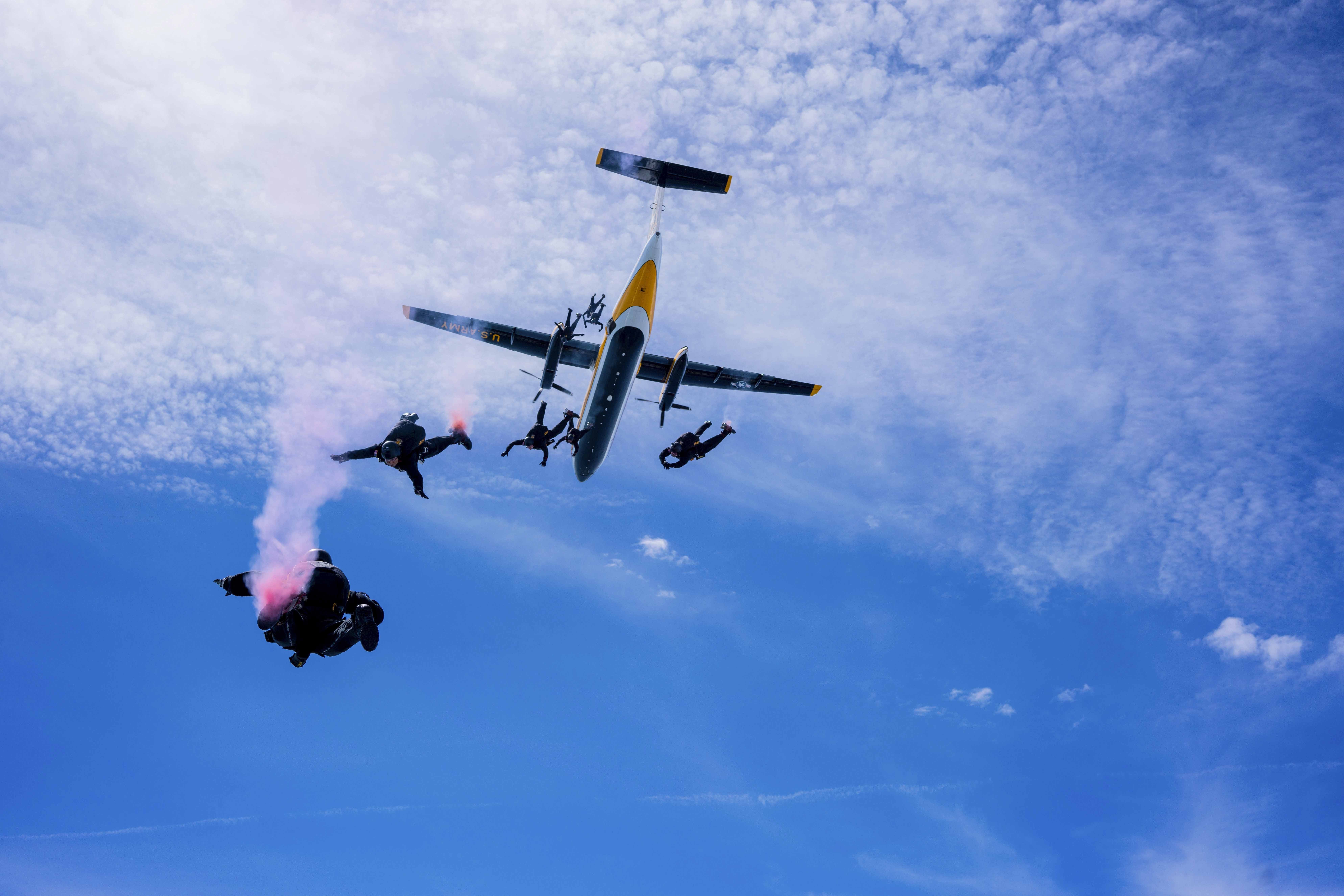 Members of the U.S. Army Parachute Team jump from their aircraft, the C-147A, for a demonstration jump at Selfridge Air National Guard Base on 8 July, 2022.  The jump is ahead of the Selfridge Open House and Air Show on July 9 and 10. (U.S. Army photo by Sgt. Mark Pierce)