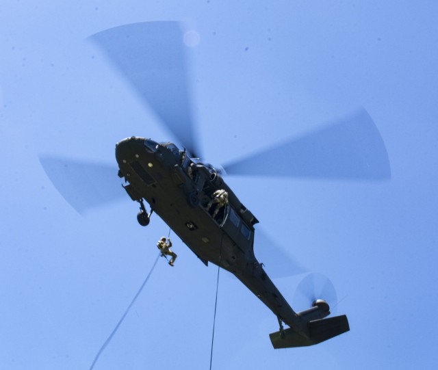 Soldiers from the 28th Expeditionary Combat Aviation Brigade hold the UH-60 Black Hawk steady as Soldiers from the Headquarters and Headquarters Company, 1st Battalion, 110th Infantry Regiment, 2nd Infantry Brigade Combat Team, rappel down during training at Fort Indiantown Gap, Pa., on Aug. 3, 2022. The training was practice and preparation for the Soldiers to rappel from the Black Hawk onto a building (U.S Army photo by Sgt. 1st Class Matthew Keeler)