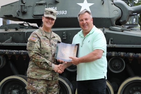 Sgt. 1st Class Michelle Paris (left), a combat medic assigned to Regional Health Command Europe, was awarded the Department of the Army Safety Guardian Award by Mr. Charles Lewis (right), Safety Program Manager for Regional Health Command Europe during a ceremony held at RHCE headquarters on Wed. Aug 31.