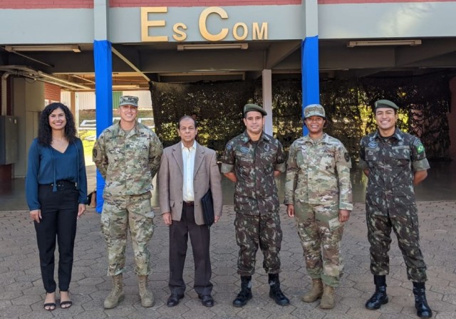 New York National Guard cyber protection experts Capt. Andrew Carter, second from left,  the information systems officer for the 42nd Infantry Division headquarters battalion, and Chief Warrant Officer 2 Nefertiti Stokes, second from right, a member of the 173rd Cyber Protection Team, with Brazilian counterparts at the Brazilian military communications school in Brasilia, Brazil, Aug. 17, 2022. The Americans took part in Brazil’s annual Cyber Guardian Exercise as part of the New York National Guard State Partnership Program relationship with Brazil. ( Photo Courtesy Capt. Andrew Carter)